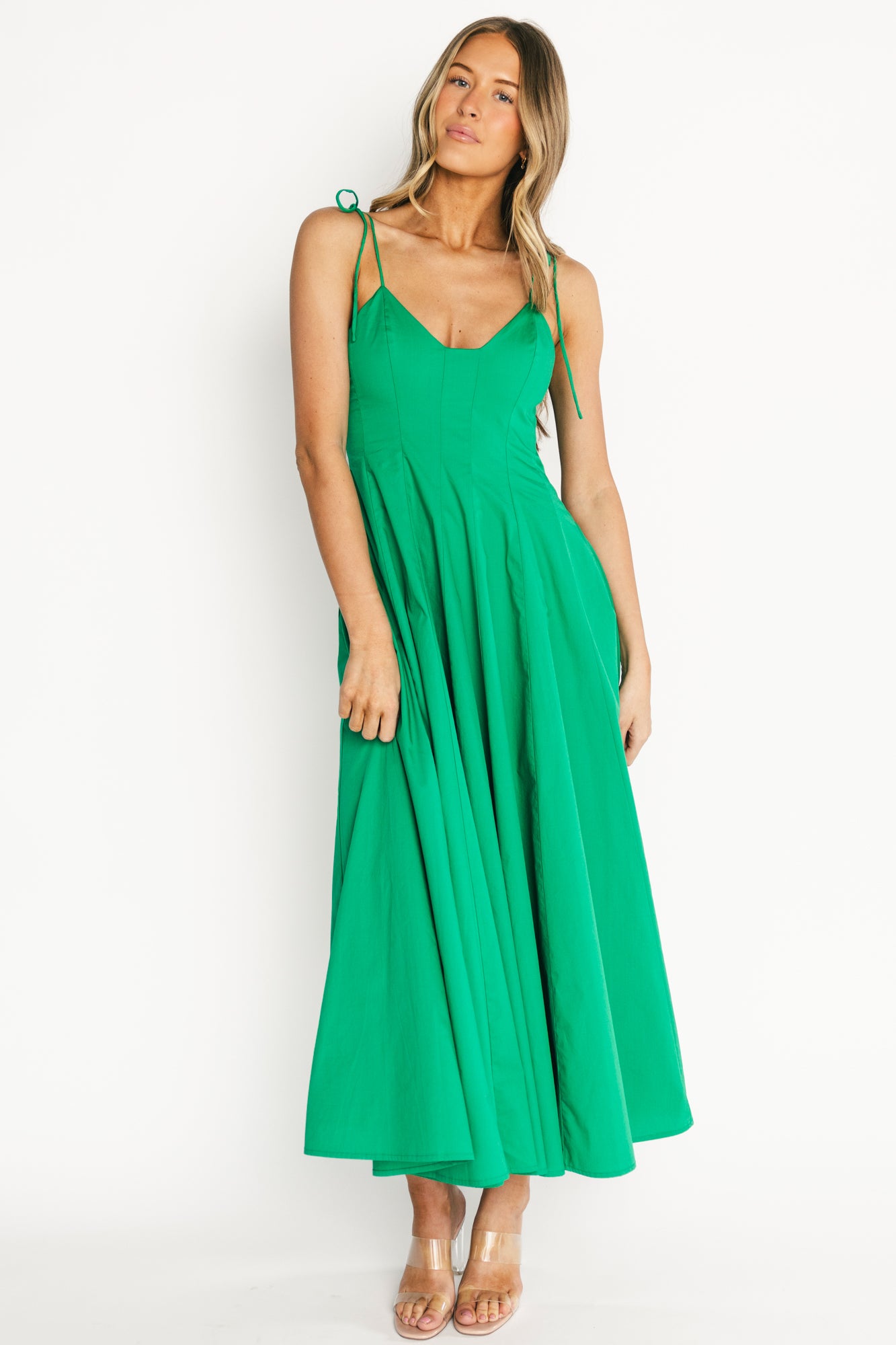 Full-length front view of the green Kitty Maxi Dress on a model, V-neck and fitted bodice with a flowing A-line skirt for a graceful silhouette.