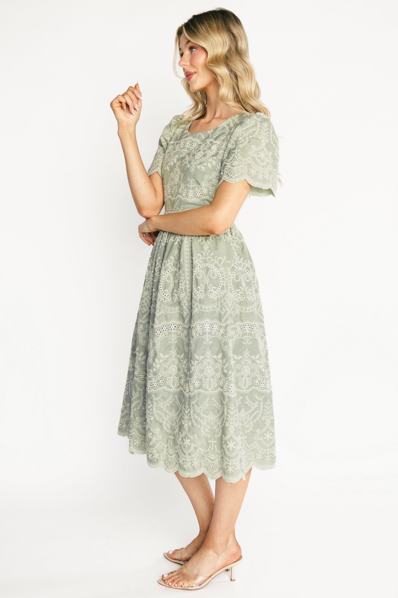 Back view of Margot Eyelet Midi Dress showing elastic back waist, keyhole button closure, and scalloped sleeve edge.