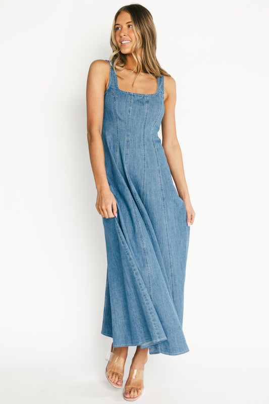 Front view of medium wash Annie denim maxi dress with square neckline, fitted bodice and flared A-line skirt for movement.