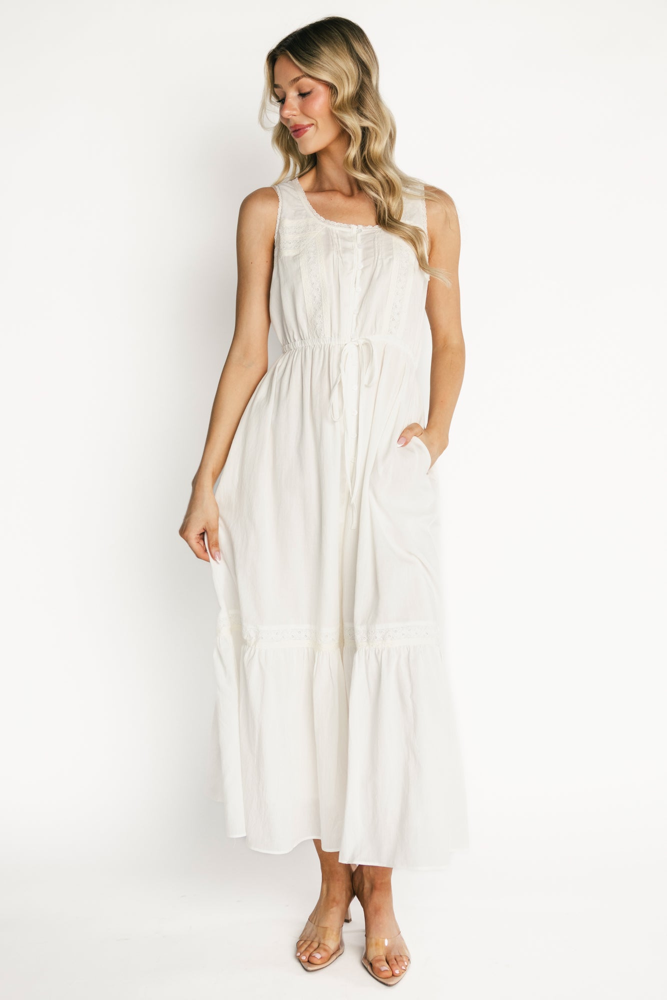 Back view of Blanche midi dress showing button-down back detail at bodice, gentle waist shaping from drawstring ties, and lined skirt.