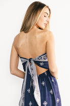 Back view of Córdoba jumpsuit highlighting back tie, elastic waistband, and the navy abstract print on lightweight fabric.