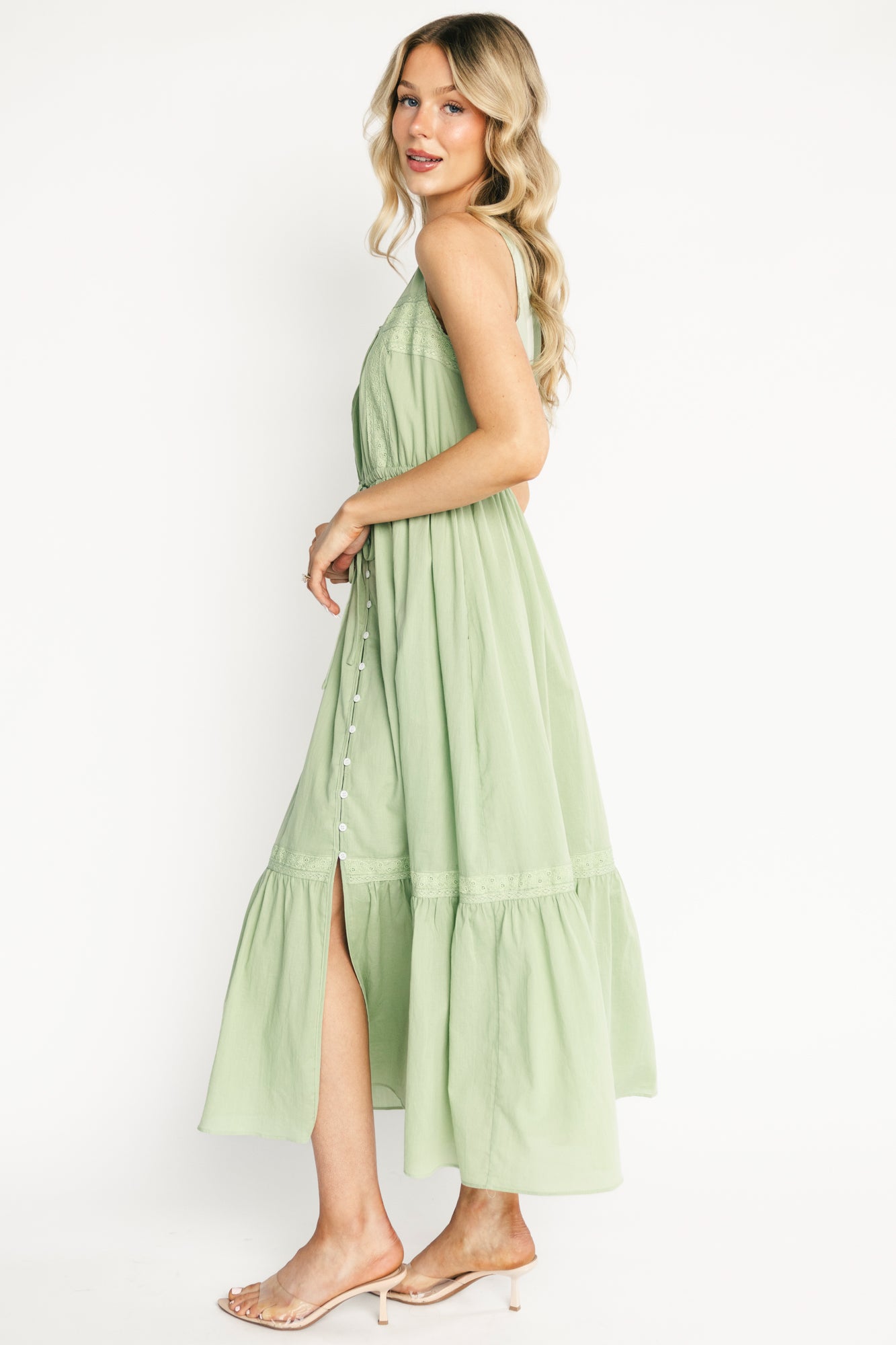 Close-up of delicate lace trim at the round neckline and decorative button-front on the sage Blanche midi dress, showing cotton texture.