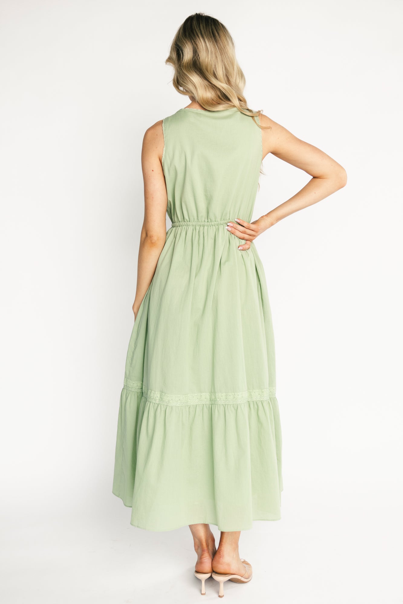 Back and side view of the Blanche midi dress in sage, displaying tiered skirt, mid-calf length and clean lined construction for coverage.