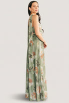 Model walking in the Dark Sage Floral maxi dress, showing natural drape, mesh stretch and wedding-guest styling with movement.
