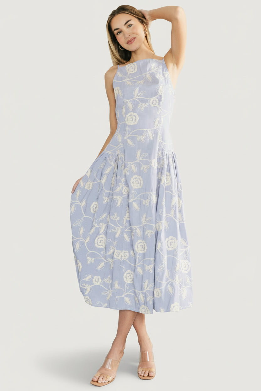 Back view of Shea Embroidered Dress showing hidden zipper and adjustable back tie, with striped pattern and mid-length skirt silhouette.