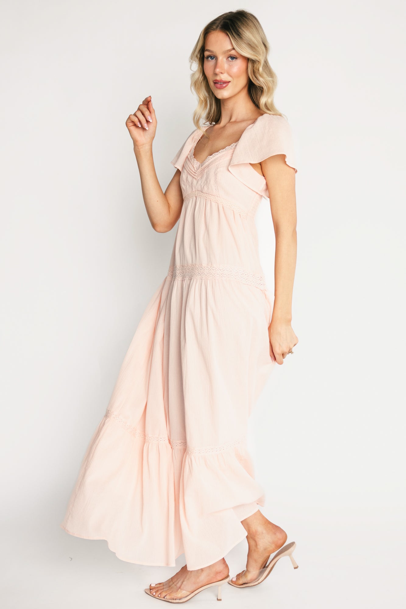 Back view of Sabine Maxi Dress in blush showing smocked back bodice that provides stretch, elastic shoulders, and full maxi-length silhouette.