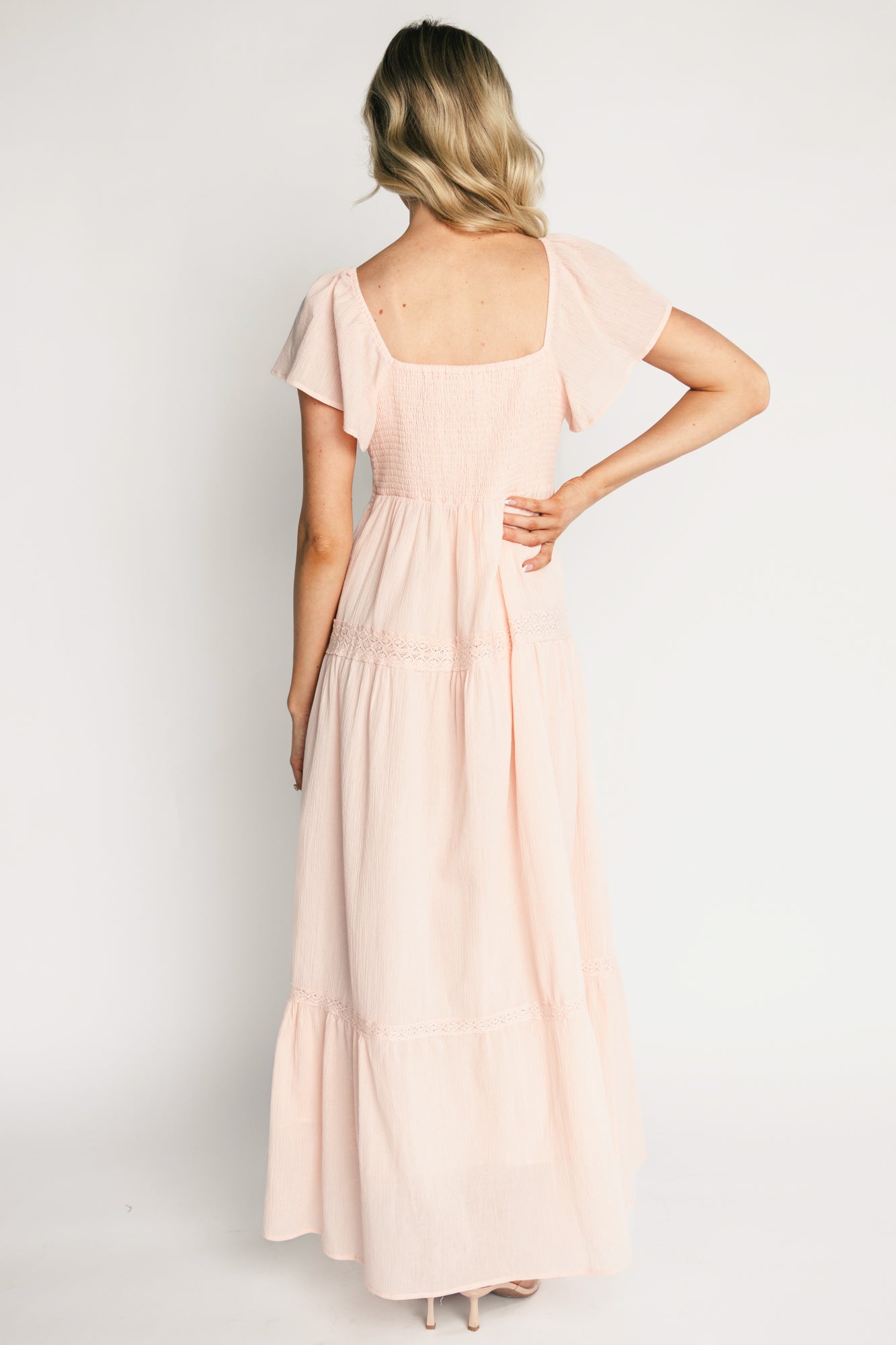 Close-up detail of Sabine Maxi Dress in blush focusing on pintuck bodice, vertical lace panels, and delicate lace trim at the V-neckline in textured cotton.