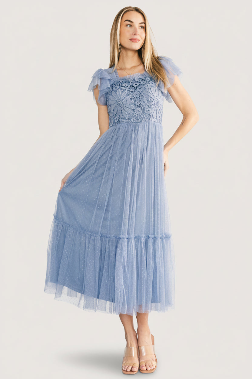 Model wearing the Elowyn lace-top midi dress in whisper blue, showing overall fit and length with lined bodice and sheer sleeves.
