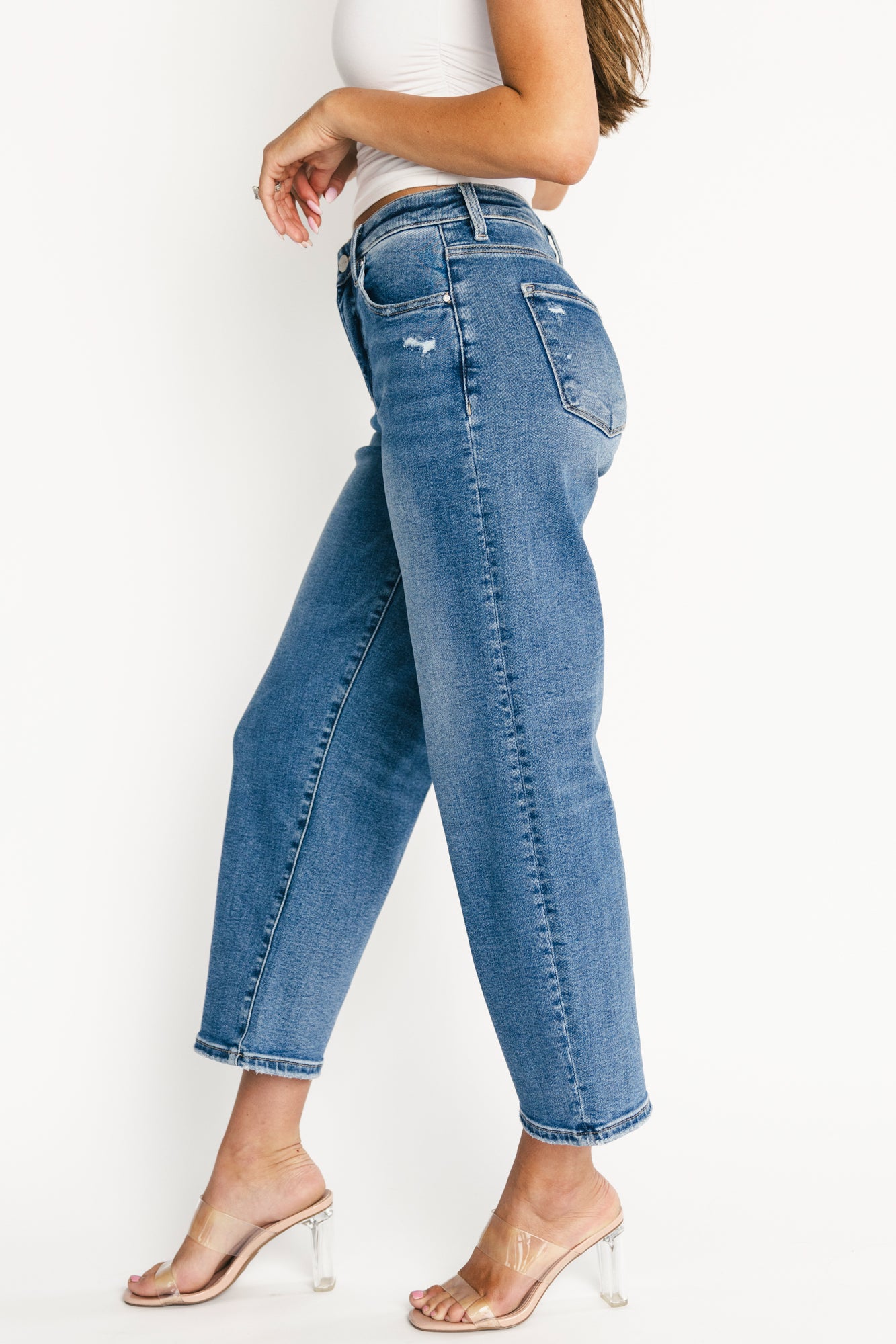 Model wearing Lumi high-rise crop barrel jeans styled with a tucked top, showing front silhouette, pocket placement, and cropped length relative to ankle.