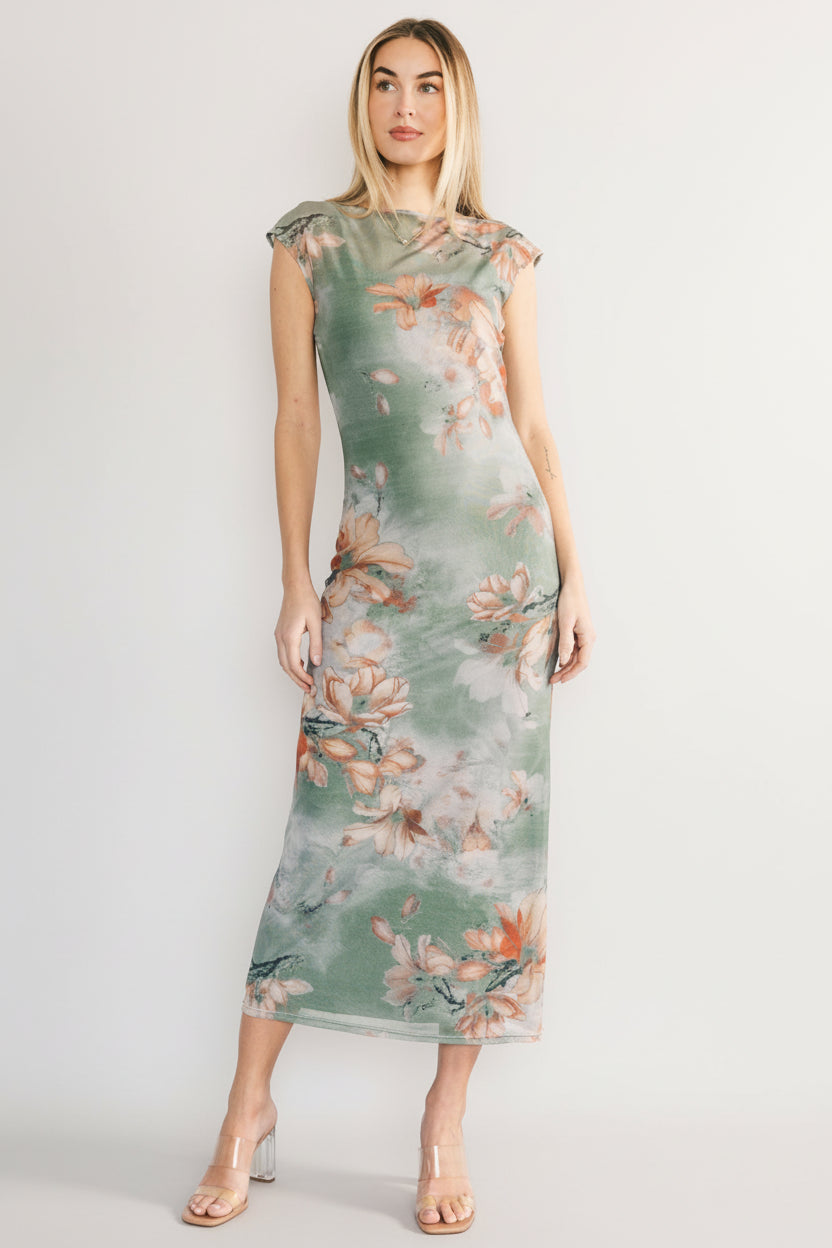 Three-quarter view showing the mesh overlay texture and orange floral pattern on the dusty sage Daniela midi dress.