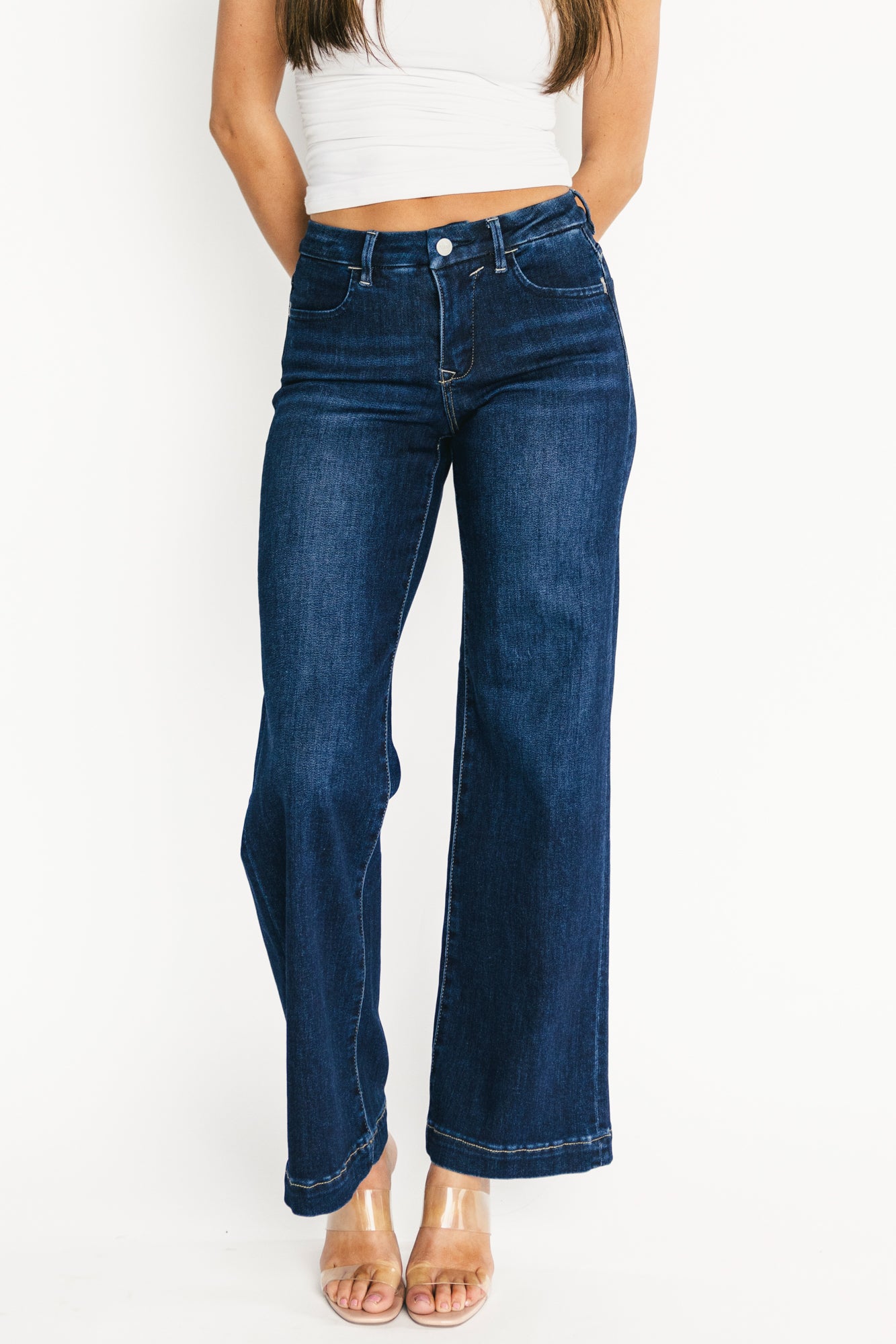 Lifestyle shot of Charme dark wash wide-leg jeans styled with casual top and shoes, showing natural movement of fabric.