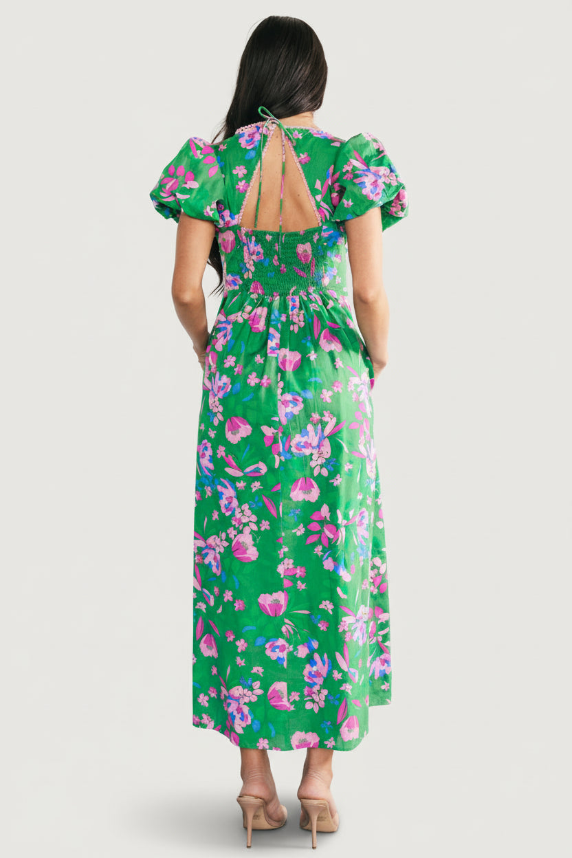 Close-up of light pink lace trim at the plunging V-neck and the cotton fabric pattern of the green multi floral print.