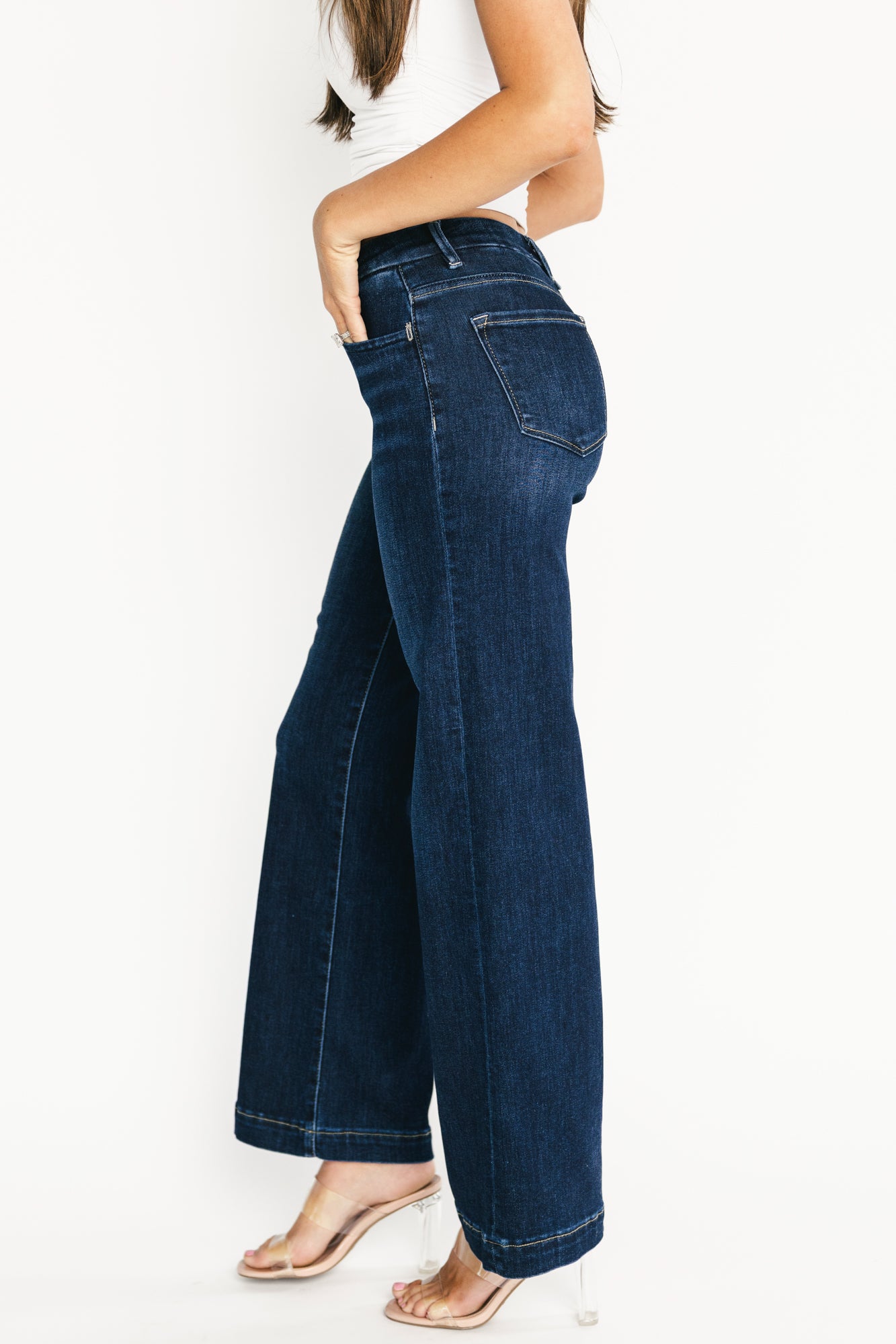Back view of model in Charme wide-leg jeans showing rear pockets, clean dark wash and relaxed leg drape.