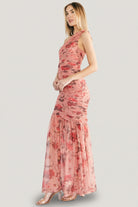 Studio portrait of the Emeline dress angled to show the one-shoulder neckline, ruched bodice and overall feminine silhouette.