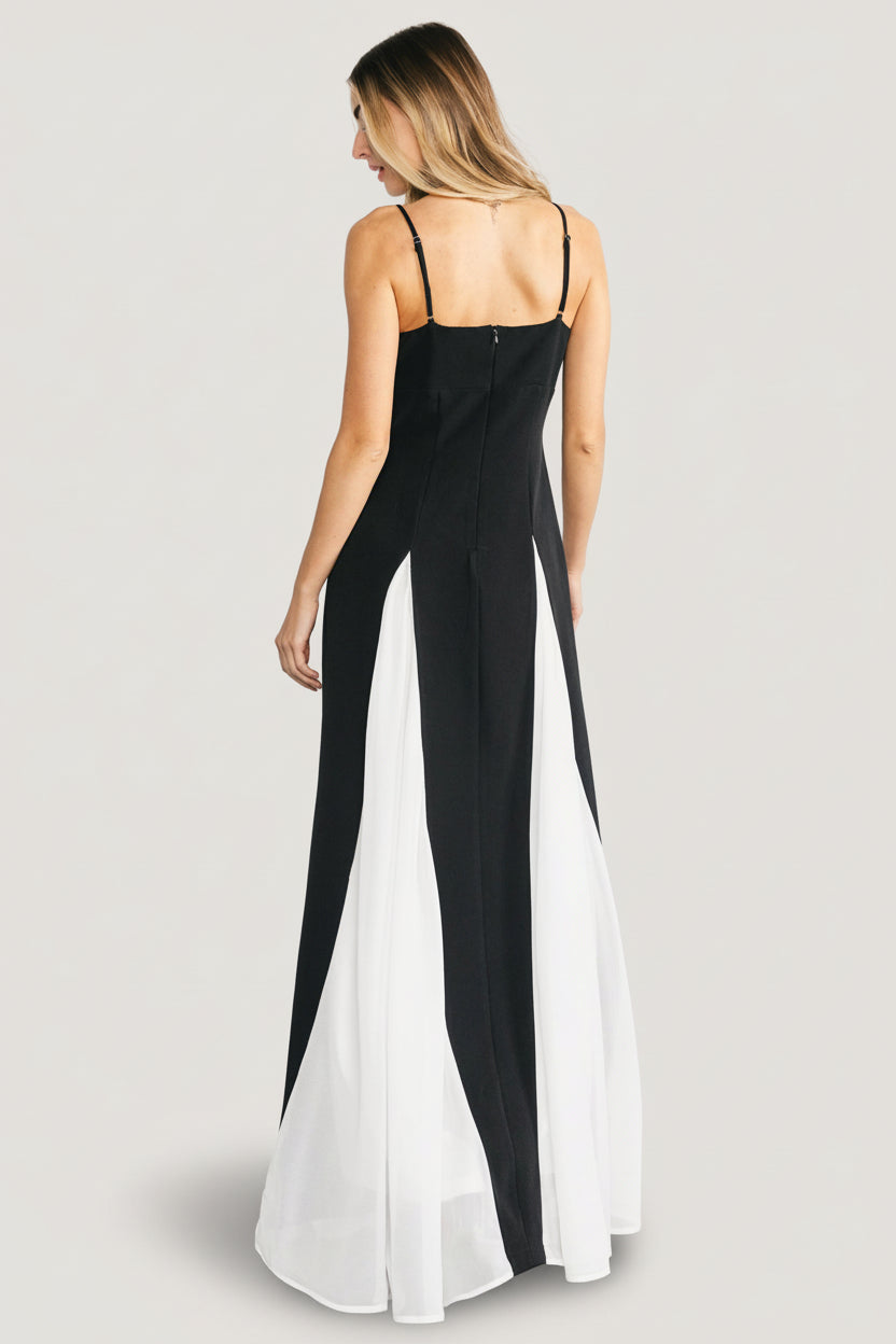 Adela dress on model styled with minimal jewelry, showing contrast panels and flowing hem for formal occasions.