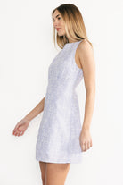 Lifestyle image of model wearing the Yvonne sleeveless dress styled with sandals outdoors, showing length and relaxed movement.
