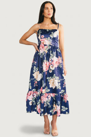 Side profile of Cherie midi dress in navy multi floral, showing adjustable spaghetti strap and side pocket detail.