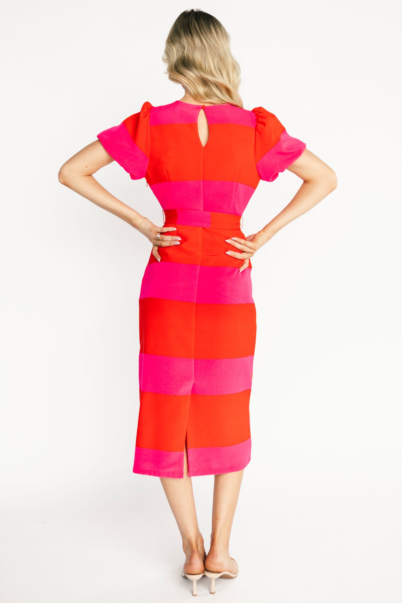 Back-detail image of Andi dress showing keyhole and button closure, back seam shaping, and the gentle back slit at the hem for ease of movement.