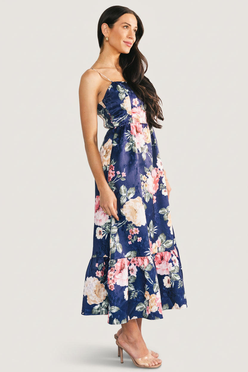 Styled outfit shot: navy floral Cherie Midi paired with sandals, demonstrating length and day-to-night versatility.