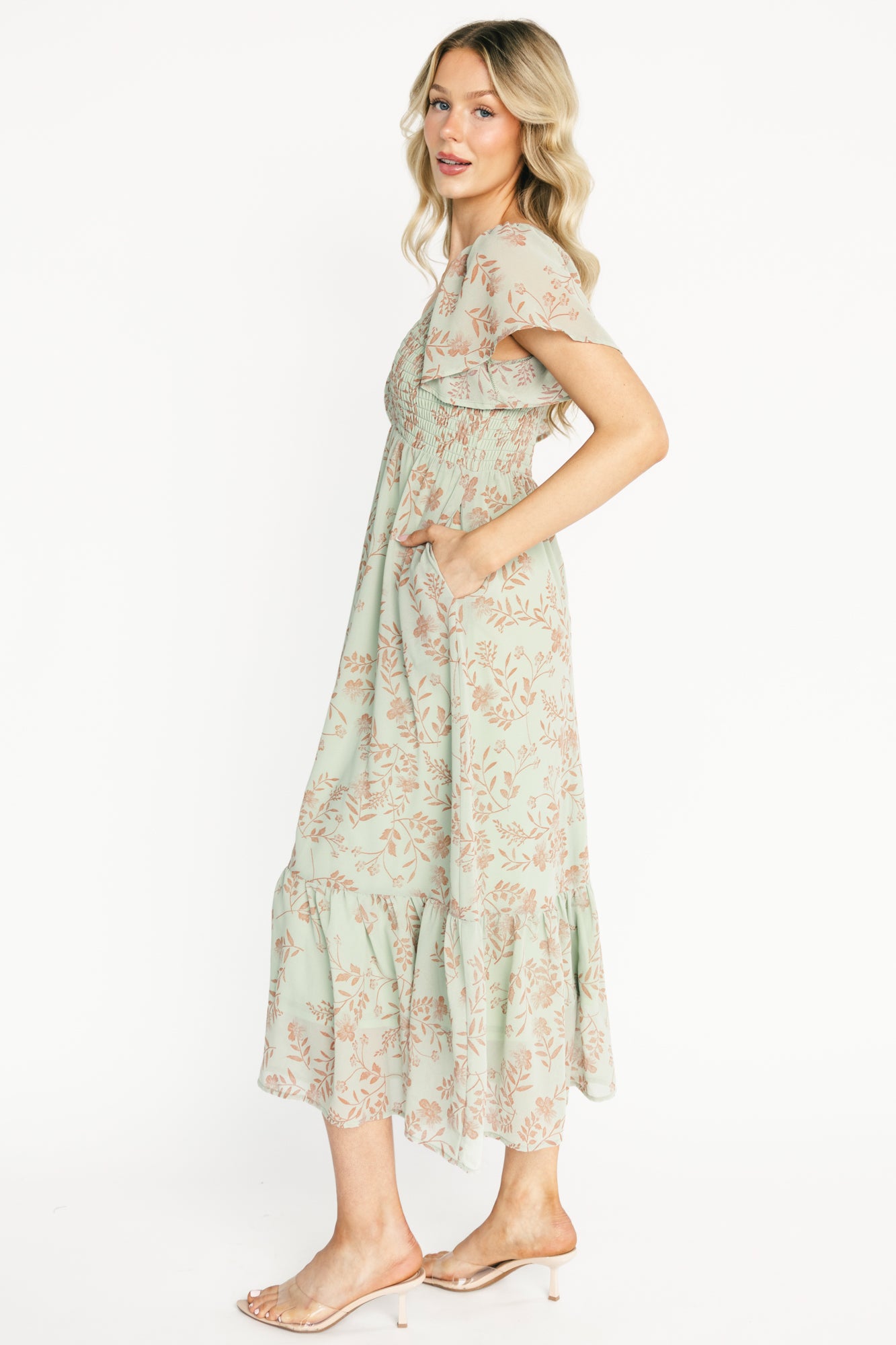 Detail shot of the lightweight chiffon overlay and the fully lined skirt, highlighting fabric texture and terracotta floral print on dusty sage.