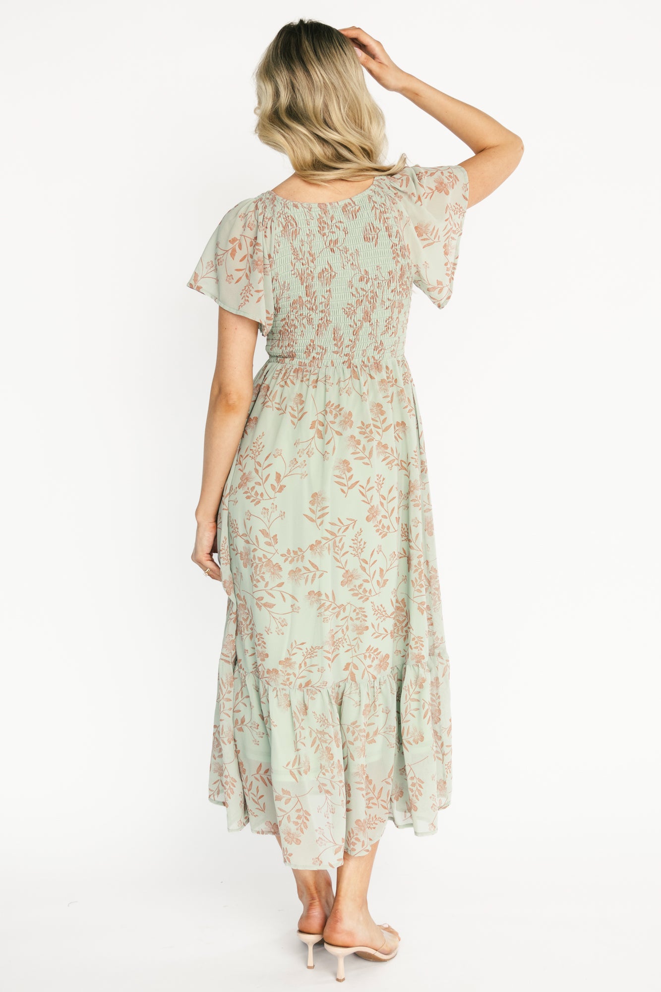 Back view of Monica Smocked Maxi Dress in dusty sage with terracotta florals, showing smocked back detail and full maxi-length hem.