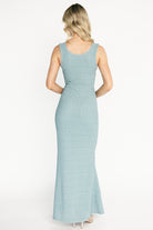 Styled full-length shot of the dusty light blue Desi Shimmer maxi gown on model, showing flow, length, and subtle sparkle.