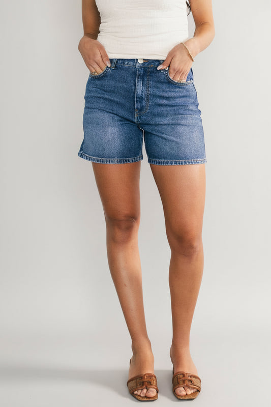 Front view of Lennon High-Rise Jean Shorts in medium-wash denim, showing frayed hem, high-rise waist, and front pockets.