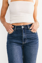 Product lifestyle image of the Kirby dark wash wide-leg jeans on model in a casual pose, emphasizing the relaxed fit and versatile dark denim tone.