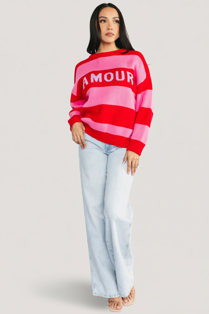 Lifestyle shot of the Amour Striped Sweater styled with jeans, showing overall fit, stripe placement, and casual outfit pairing inspiration.