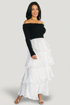 Back view of Maelie dress showing seam lines, skirt tiers, and the contrast between the black sweater top and white satin skirt.