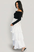 Close-up of bodice texture and ribbed sweater fabric highlighting the fitted stretch top and twist neckline detail.