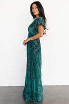 Back and side view of the emerald Kimberly velvet burnout maxi dress, showing skirt drape and subtle sheen of the velvet pattern.