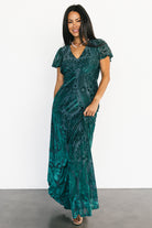 Styled outfit shot of the Kimberly emerald velvet burnout maxi dress paired with accessories, illustrating eveningwear styling options.