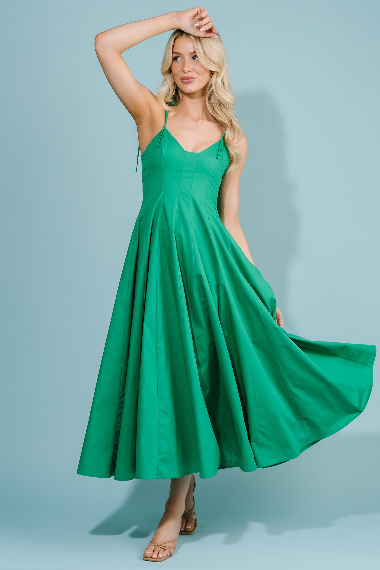 Close-up of the fitted bodice and V-neckline with adjustable self-tie straps, showing stitch detail and neckline shape.