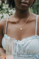 Studio portrait of the Mother of Pearl Broadwater pendant on an 18K gold-plated rope chain, showing square-cut stone and polished gold bezel close-up.