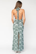 Detail shot of the sequined leaf pattern and hem edge, showing texture, shimmer, and the maxi-length drape on mesh fabric.