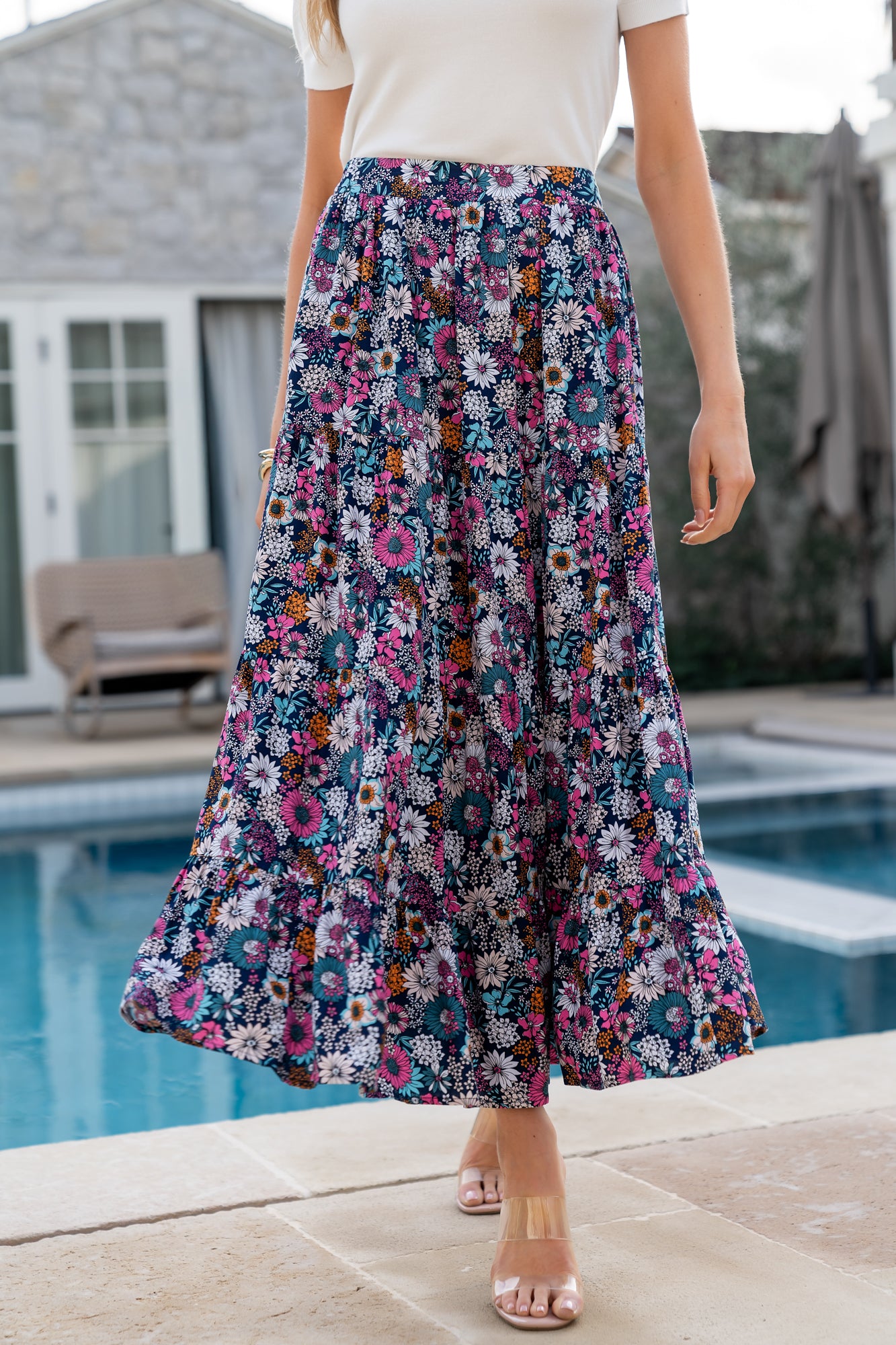 Front view of navy floral maxi skirt on a model, showing full length, print detail, and smocked back waistband.