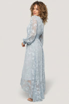Model shot of the Daniella dress in motion, showing the flowing high-low skirt and soft drape of the burnout floral chiffon fabric.