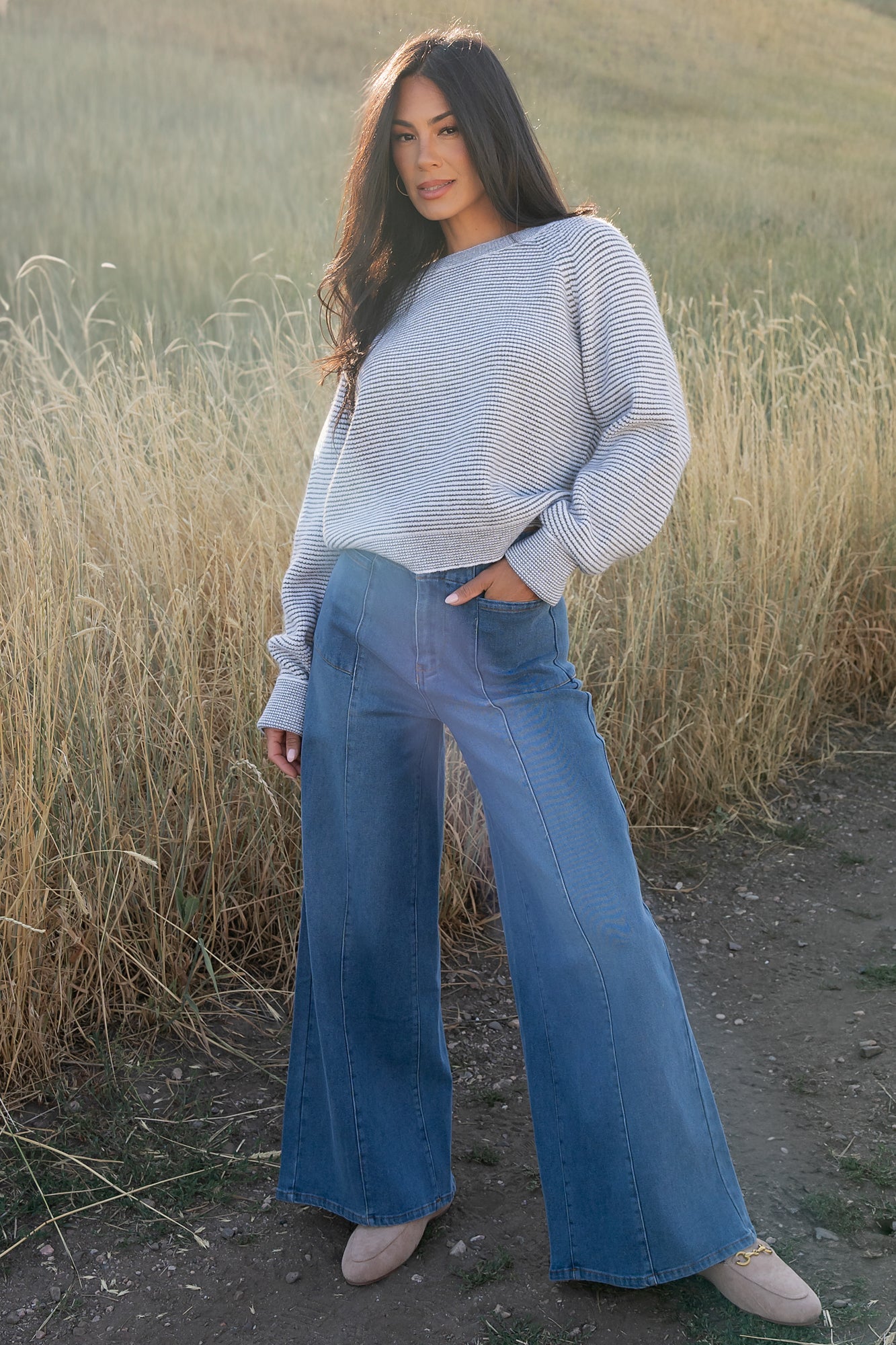 Model side view of Zadie Sweater highlighting raglan sleeve cut, high round neckline, and contrast binding at the neckline.