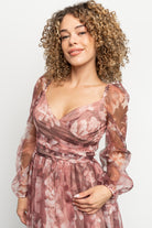 Side profile of the Nara Dress in deep mauve floral, highlighting flowing skirt, left leg slit and soft tulle movement.