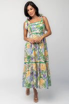 Model wearing the Torres Midi Dress featuring a multicolor floral print with green accents.
