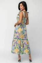 Model wearing the Torres Midi Dress featuring a multicolor floral print with green accents.