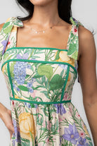 Model wearing the Torres Midi Dress featuring a multicolor floral print with green accents.
