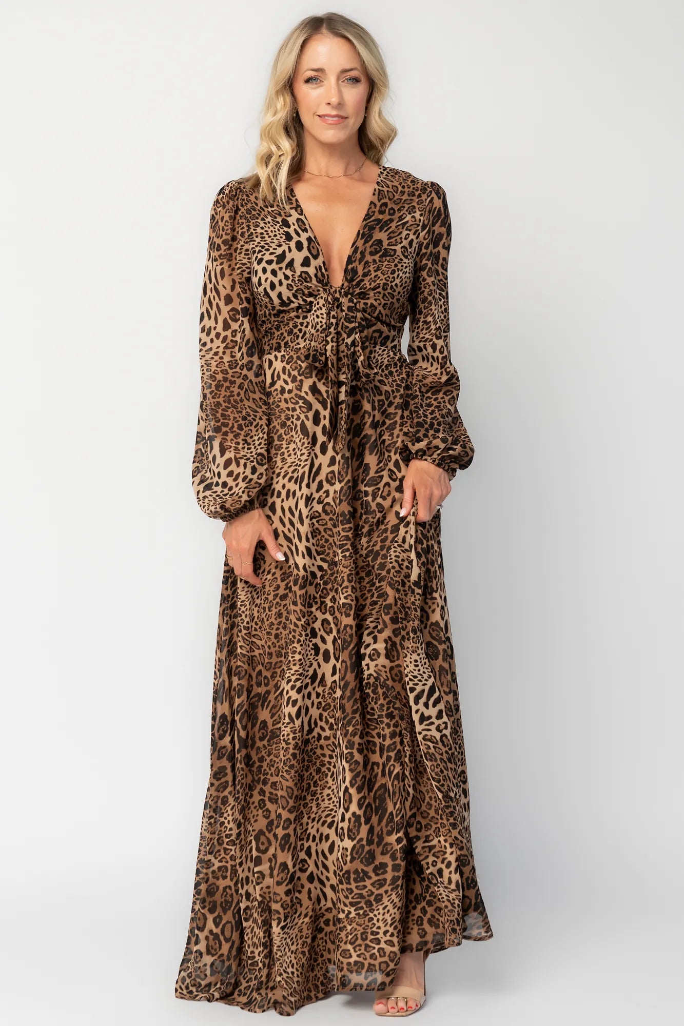 Model wearing a maxi dress with a mixed animal print, featuring a V-neckline with a keyhole cutout and front tie detail.