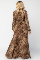 Model wearing a maxi dress with a mixed animal print, featuring a V-neckline with a keyhole cutout and front tie detail.