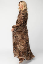 Model wearing a maxi dress with a mixed animal print, featuring a V-neckline with a keyhole cutout and front tie detail.