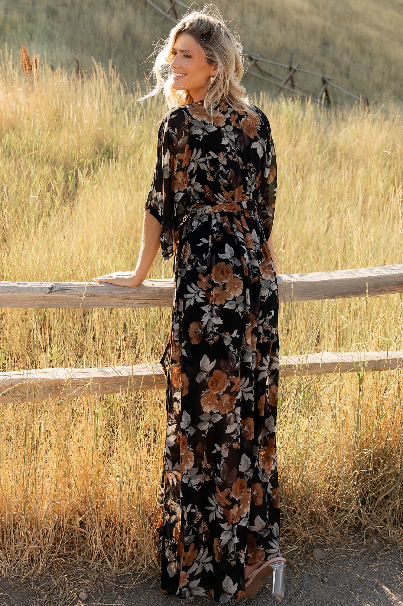 Close-up of black fabric with copper and light gray floral print highlighting the texture and soft lightweight polyester drape.