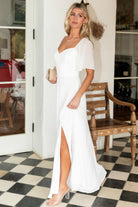 Studio full-length shot of the Sierra Sweetheart Maxi Dress in white on a model, highlighting fit, length, and chiffon overlay.