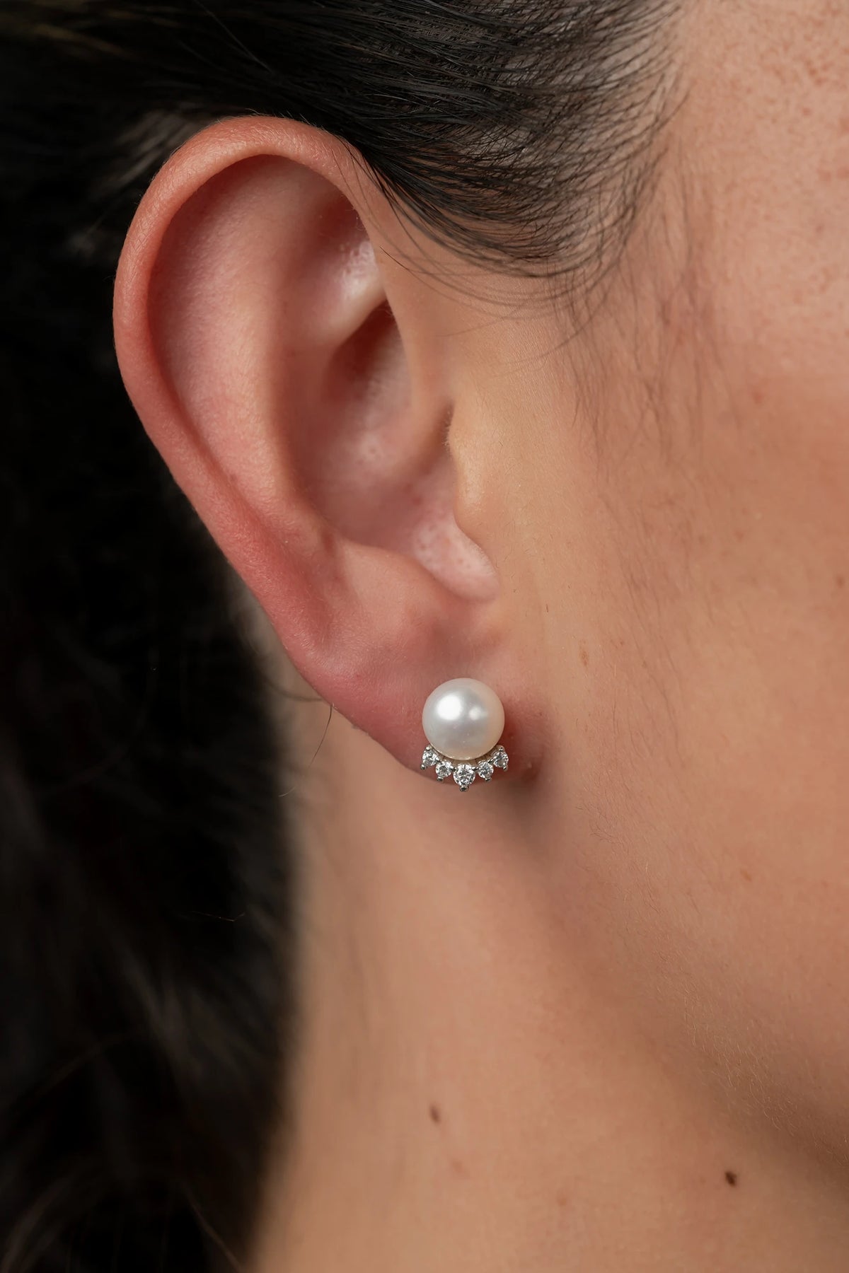 Livvy Pearl Stud Earrings with glossy pearl centers, polished sterling silver settings, and classic post backs.