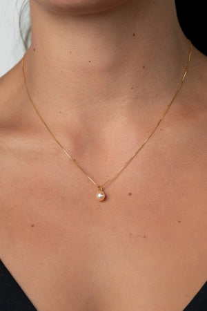 Tanaia Pearl Necklace in Gold with a freshwater light pink pearl and delicate gold-tone chain.